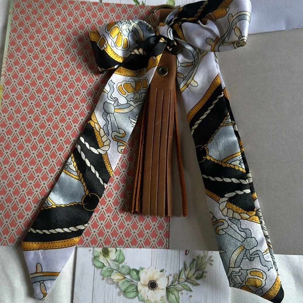 Brown TASSEL KEYCHAIN/bag charm with detachable scarf.
